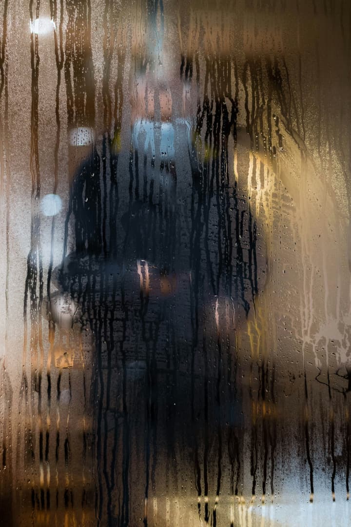 Humidity droplets on window showing balance between humidity and heating