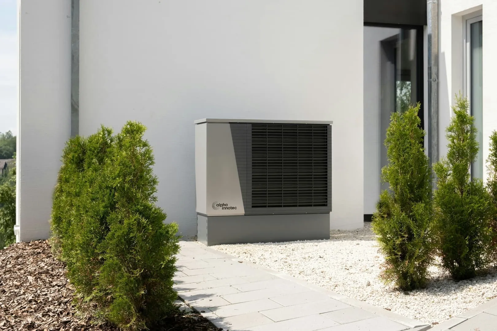 Modern heat pump installed in front of a house - 2025 grants and subsidies